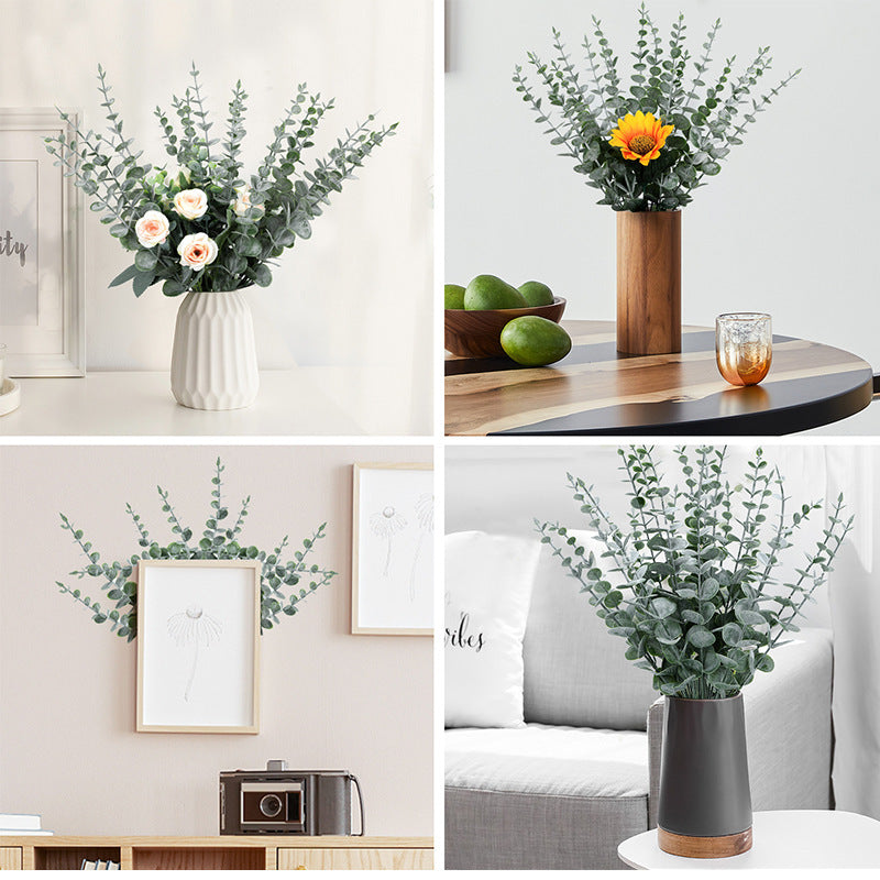 Faux eucalyptus stems styled in vases